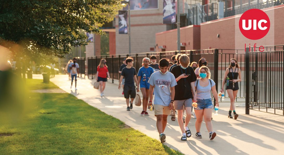 Students walking down a sidewalk on campus