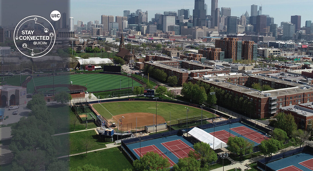 Outdoor green athletic fields at UIC campus against background of Chicago skyline