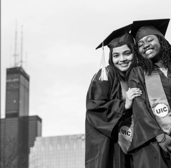 UIC Alumni in cap and gown with city background
                  