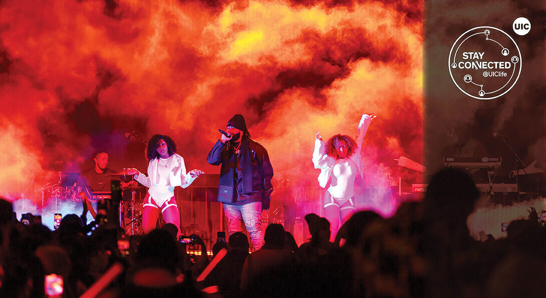 college crowds enjoys live concert with smoke and orange lighting