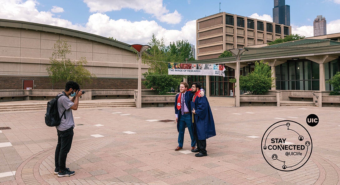 A photographer takes graduation photos at the Quad at UIC.