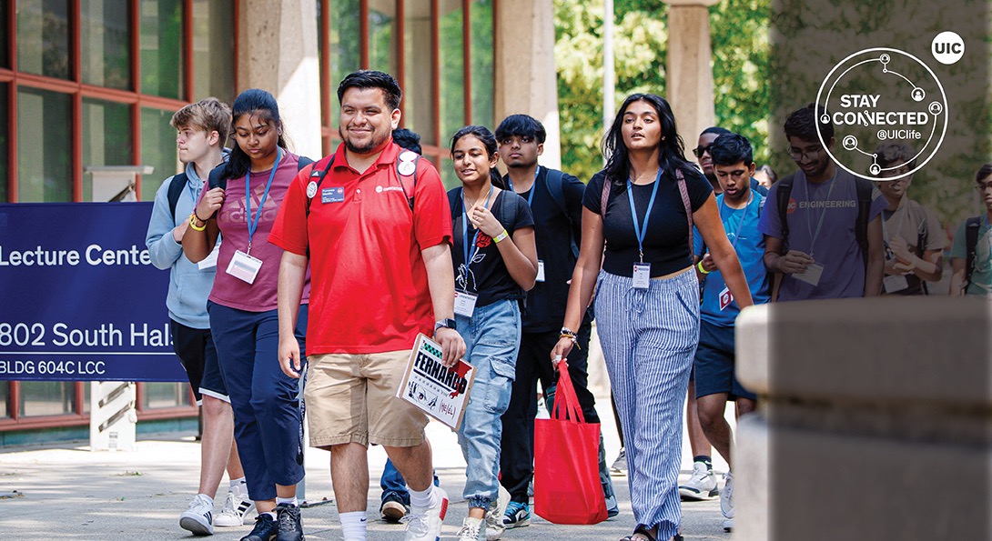 Orientation Leader at UIC walking with a group of new students.