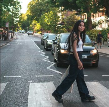 Student crossing the famous Abbey Road in London
                  