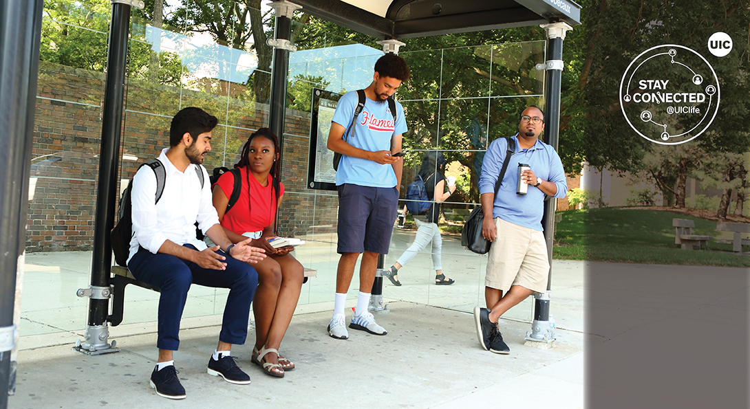 Four UIC commuter students at a bus stop